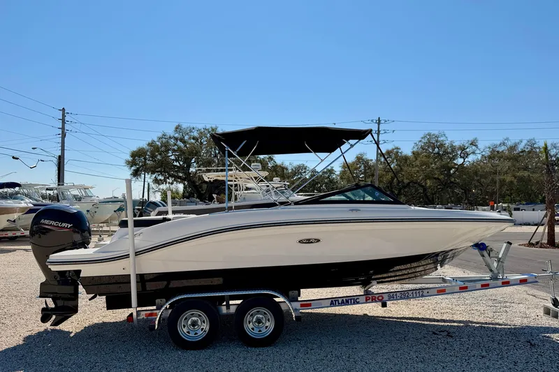 Slide: The Image of 2023 Sea Ray SPX 210 Outboard boat on trailer, parked outdoors. - 4