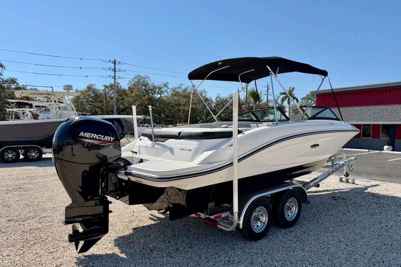 Slide: The Image of 2023 Sea Ray SPX 210 Outboard boat on trailer, featuring a Mercury engine. - 5