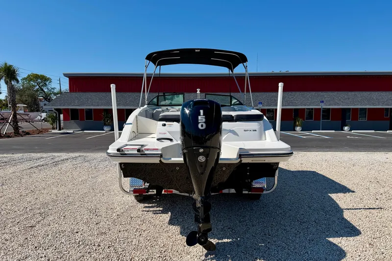 Slide: The Image of 2023 Sea Ray SPX 210 Outboard boat, rear view, parked on gravel, sunny day. - 6