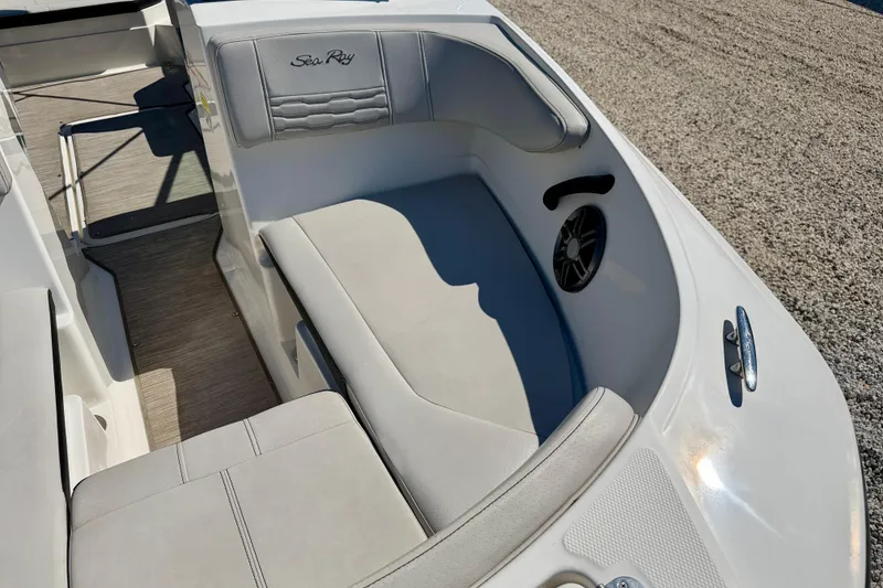 Slide: The Image of 2023 Sea Ray SPX 210 Outboard boat interior with cushioned seating and speaker. - 9