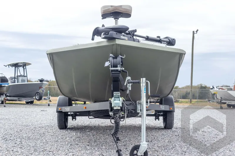 Slide: The Image of 2026 Vexus Defender 181 boat on trailer, front view, parked on gravel lot. - 12