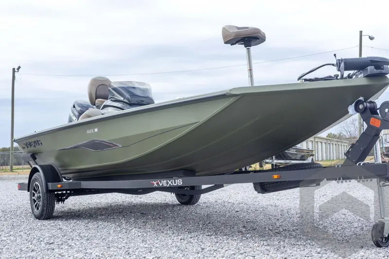 Slide: The Image of 2026 Vexus Defender 181 boat on trailer, side view, outdoors on gravel. - 13