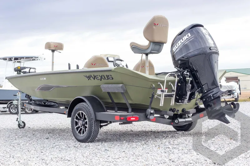 Slide: The Image of 2026 Vexus Defender 181 boat with Suzuki engine on trailer, displayed outdoors. - 17