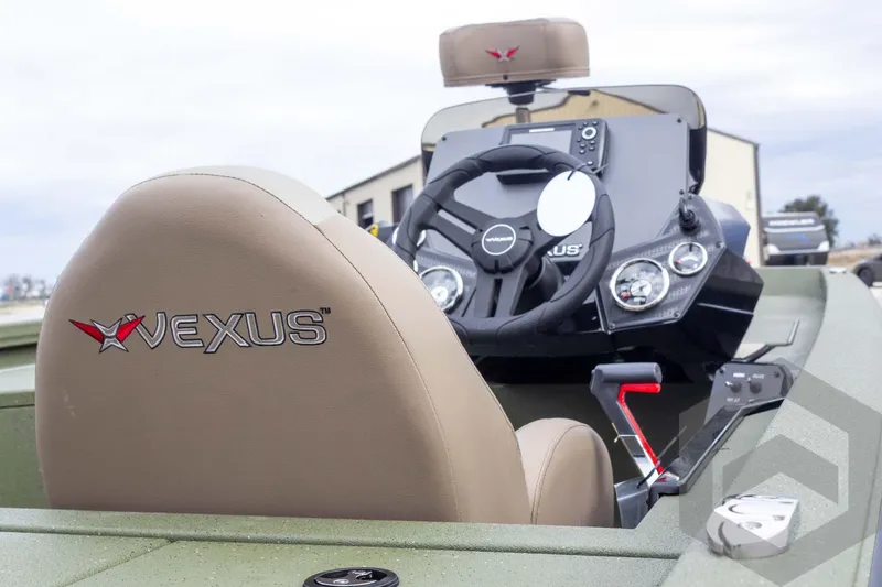 Slide: The Image of Interior view of 2026 Vexus Defender 181 boat, featuring steering wheel and dashboard controls. - 24