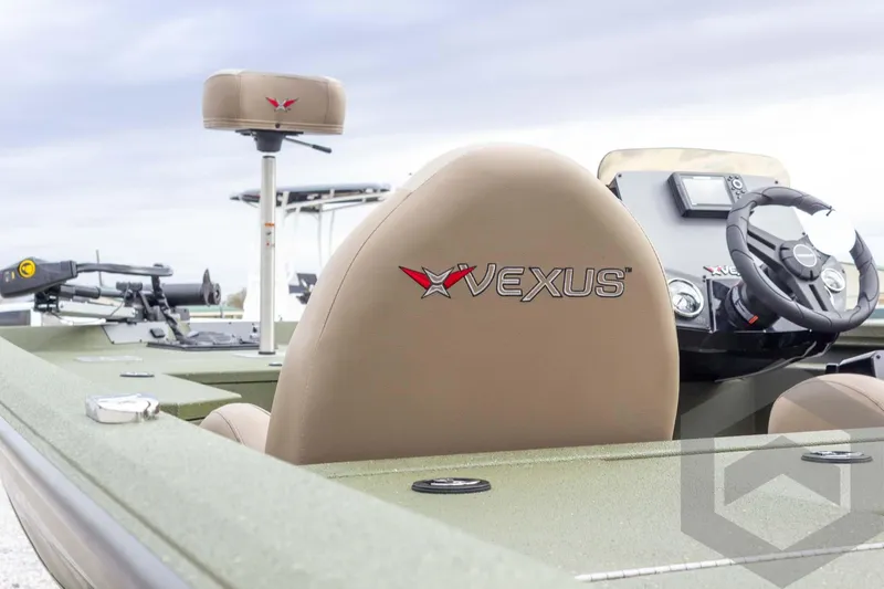 Slide: The Image of 2026 Vexus Defender 181 boat interior with branded seats and steering console. - 26