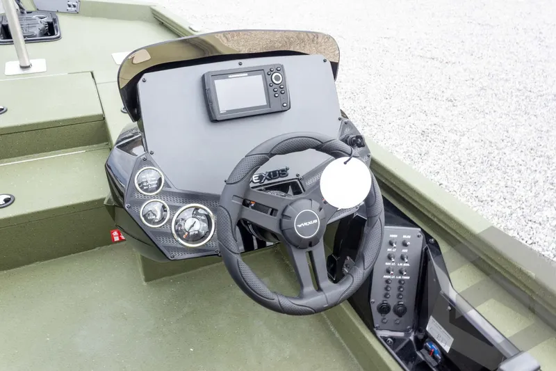 Slide: The Image of 2026 Vexus Defender 181 boat dashboard with steering wheel and control panel. - 40