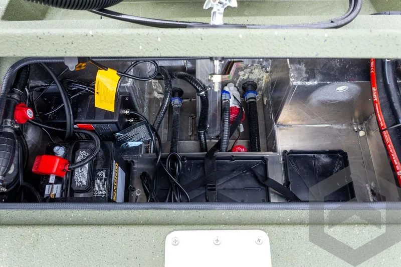 Slide: The Image of Battery compartment of 2026 Vexus Defender 181 boat, showing wiring and components. - 49