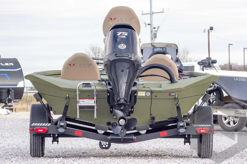 Slide: The Image of 2026 Vexus Defender 181 boat on trailer, rear view with motor and seats visible. - 5