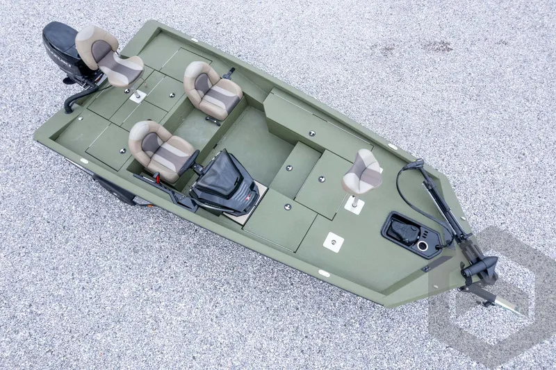 Slide: The Image of 2026 Vexus Defender 181 boat, aerial view, green with beige seats, on gravel surface. - 60