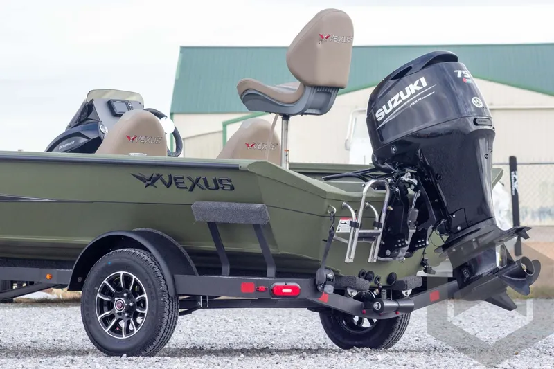 Slide: The Image of 2026 Vexus Defender 181 boat with Suzuki outboard motor, parked on gravel. - 7