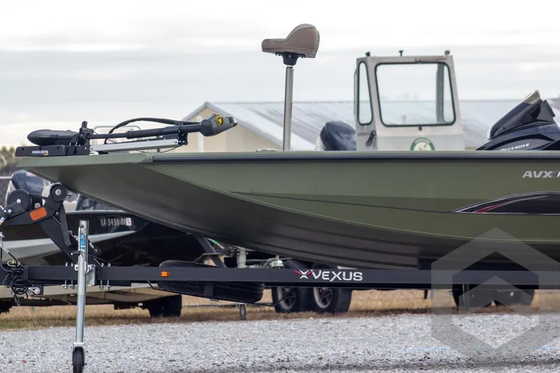 Slide: The Image of 2026 Vexus Defender 181 boat on trailer, featuring Minn Kota trolling motor. - 9