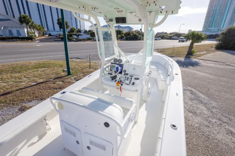 Slide: The Image of 2008 Everglades 243 Center Console boat parked near a road with buildings in background. - 11