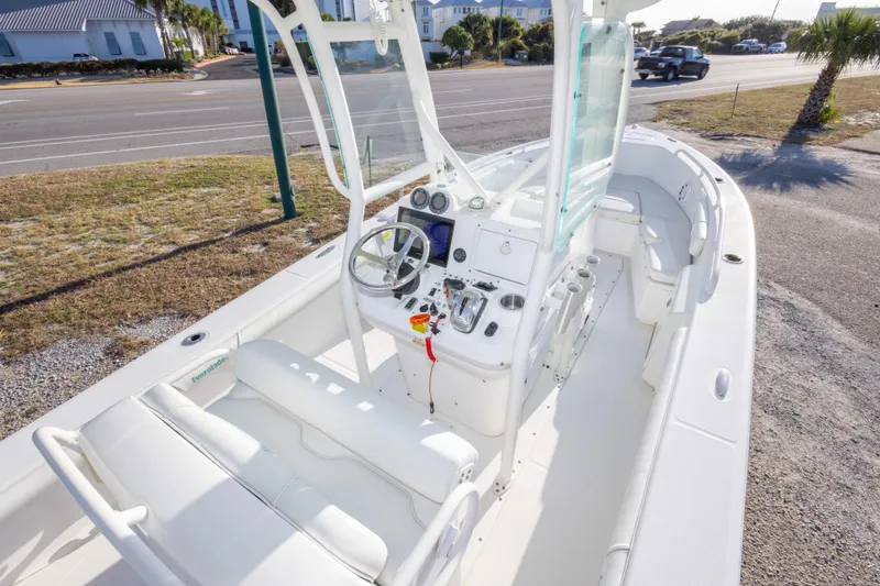 Slide: The Image of 2008 Everglades 243 Center Console boat with white interior, parked near a road. - 12