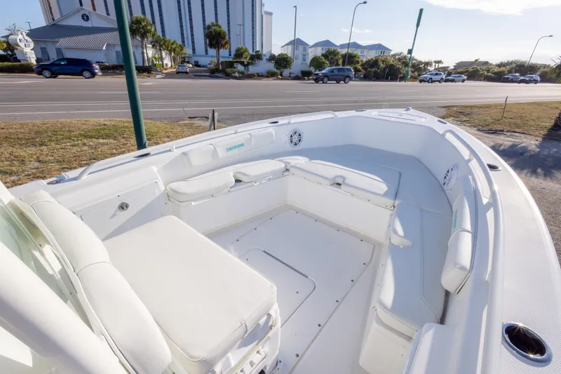 Slide: The Image of 2008 Everglades 243 Center Console boat with spacious seating, parked near a road. - 15