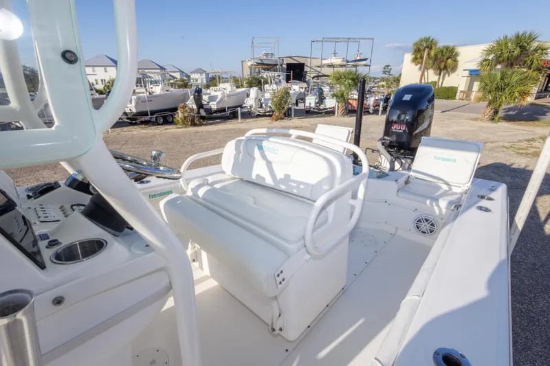 Slide: The Image of 2008 Everglades 243 Center Console boat with white seating and powerful outboard motor. - 20