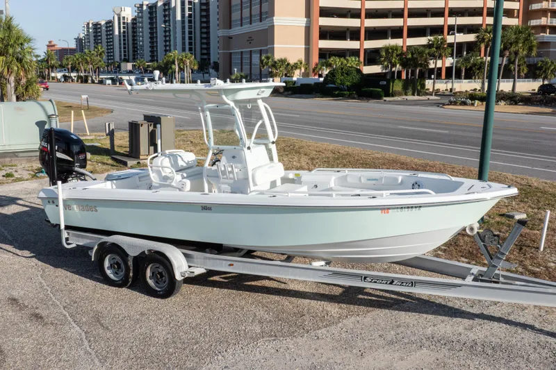 Slide: The Image of 2008 Everglades 243 Center Console boat on trailer, parked near road and buildings. - 24