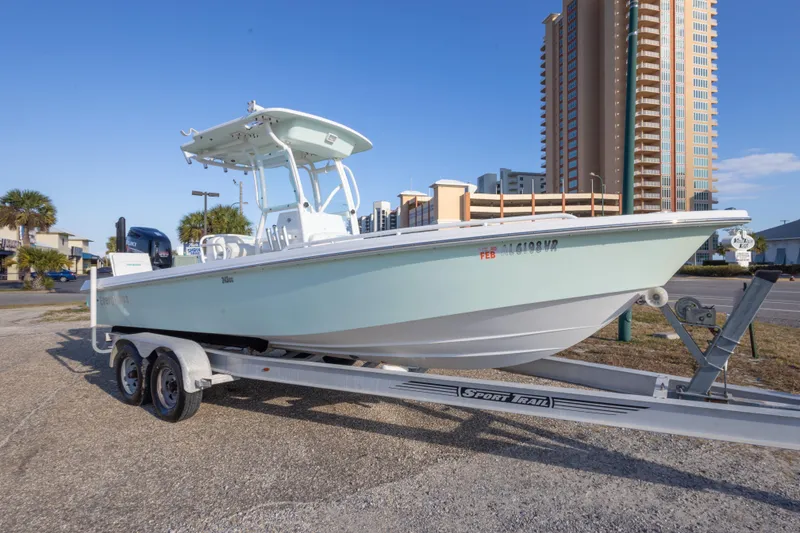Slide: The Image of 2008 Everglades 243 Center Console boat on trailer, urban backdrop, clear sky. - 3