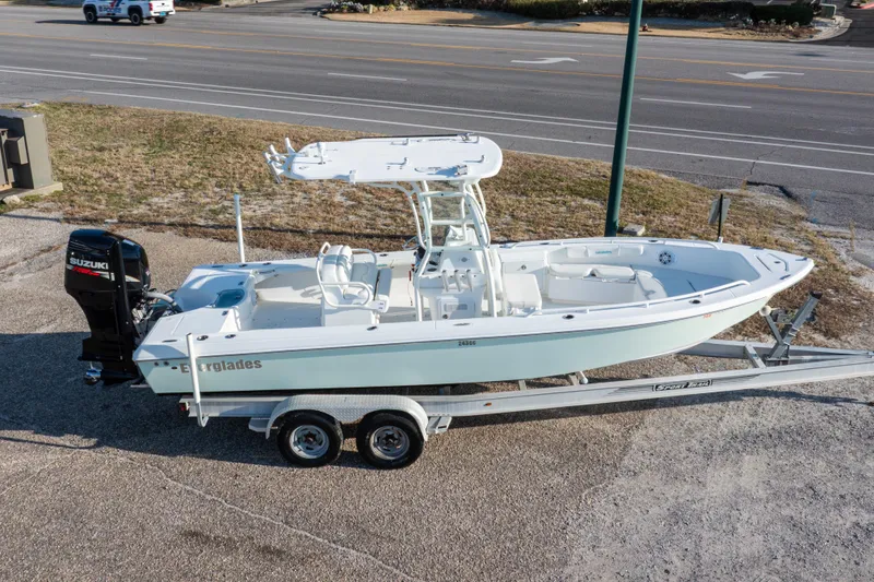 Slide: The Image of 2008 Everglades 243 Center Console boat on trailer, featuring Suzuki outboard motor. - 33