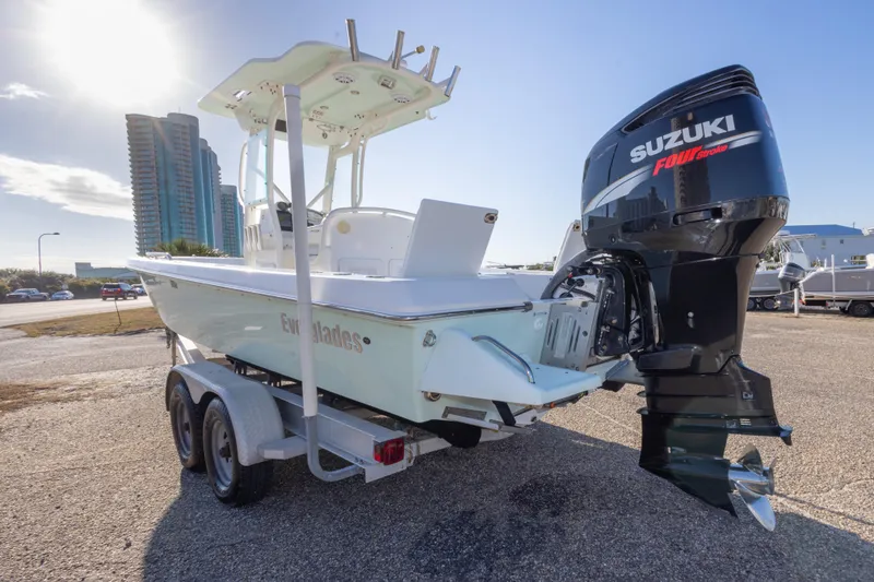 Slide: The Image of 2008 Everglades 243 Center Console boat with Suzuki engine on trailer, sunny day. - 6