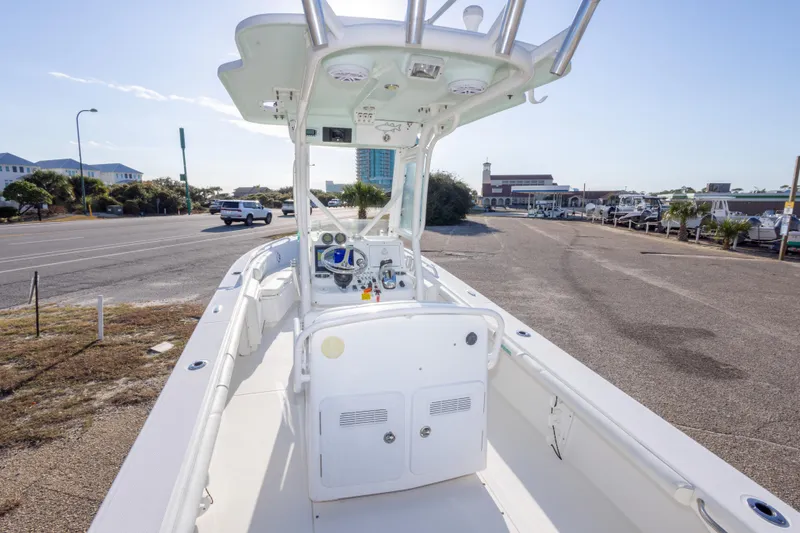 Slide: The Image of 2008 Everglades 243 Center Console boat parked near a coastal road. - 9