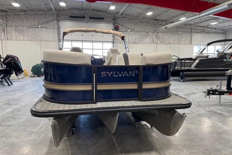 Slide: The Image of 2023 Sylvan X-3 pontoon boat in showroom, featuring sleek design and comfortable seating. - 5