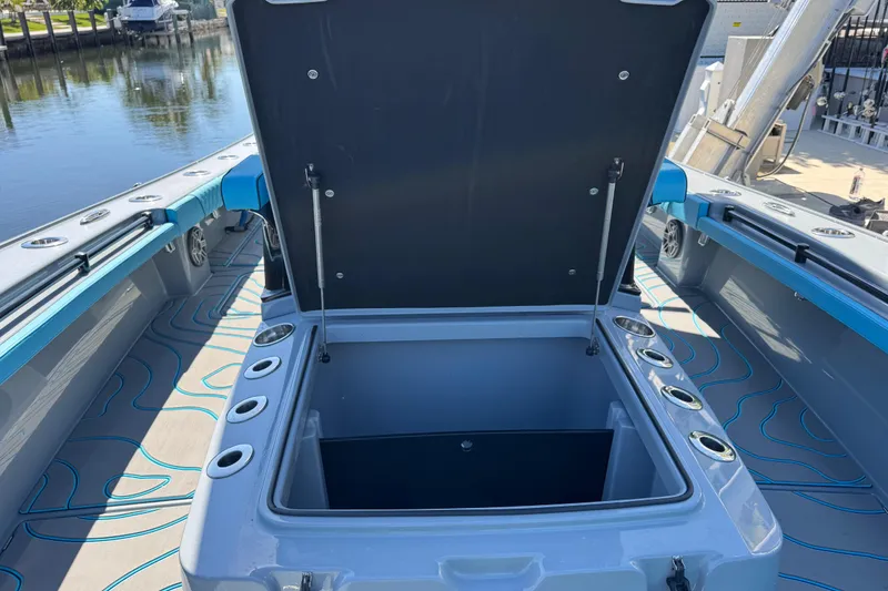 Slide: The Image of Open storage compartment on 2026 Costa Custom Boats 264 HC, dockside view. - 11