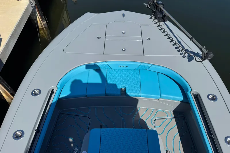 Slide: The Image of 2026 Costa Custom Boats 264 HC with blue seating and sleek design. - 16