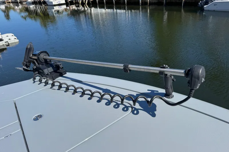 Slide: The Image of 2026 Costa Custom Boats 264 HC with trolling motor on calm water. - 17