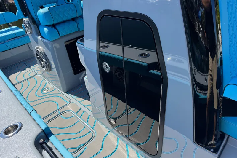 Slide: The Image of 2026 Costa Custom Boats 264 HC interior with blue seating and sleek design. - 21