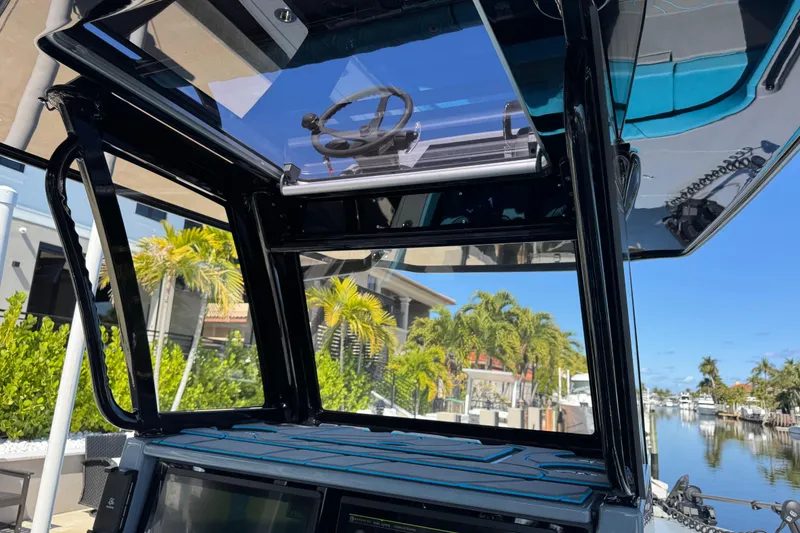 Slide: The Image of 2026 Costa Custom Boats 264 HC interior with modern design, overlooking a scenic waterfront. - 25