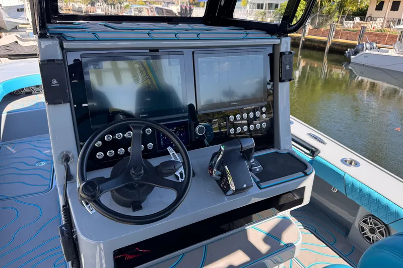 Slide: The Image of 2026 Costa Custom Boats 264 HC helm with advanced navigation displays and controls. - 26