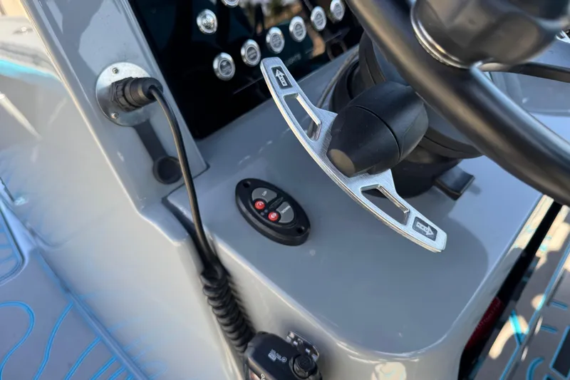 Slide: The Image of Control panel of 2026 Costa Custom Boats 264 HC, featuring steering and electronic controls. - 30