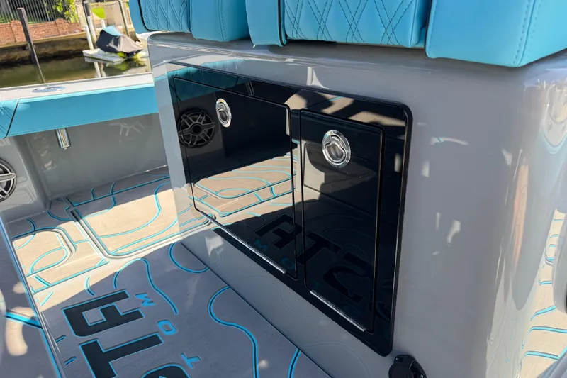 Slide: The Image of 2026 Costa Custom Boats 264 HC interior with blue seating and sleek storage compartments. - 32