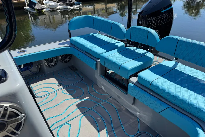 Slide: The Image of 2026 Costa Custom Boats 264 HC interior with blue seating and stylish flooring design. - 34