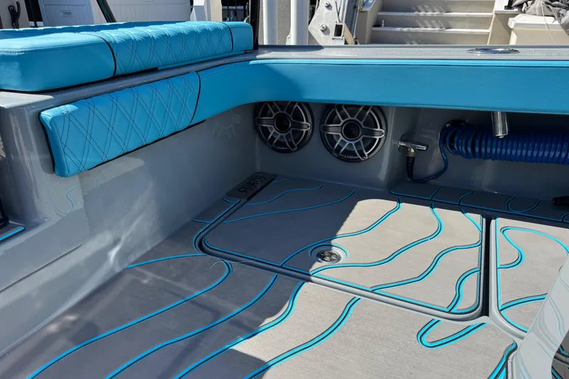 Slide: The Image of 2026 Costa Custom Boats 264 HC interior with blue seating and marine speakers. - 37