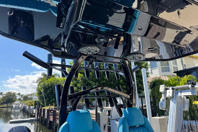 Slide: The Image of 2026 Costa Custom Boats 264 HC with sleek black canopy and blue seating. - 41