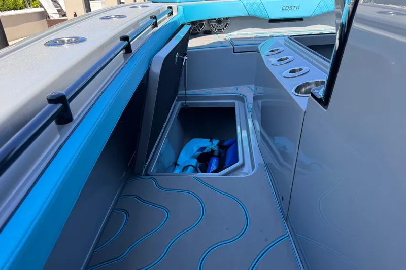 Slide: The Image of 2026 Costa Custom Boats 264 HC interior with storage compartment and modern design. - 45
