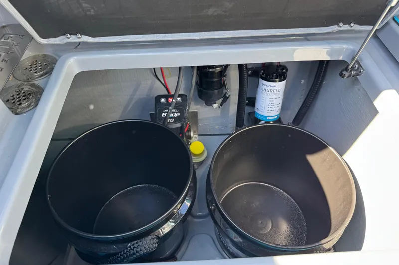 Slide: The Image of Storage compartment of 2026 Costa Custom Boats 264 HC with equipment and wiring. - 46