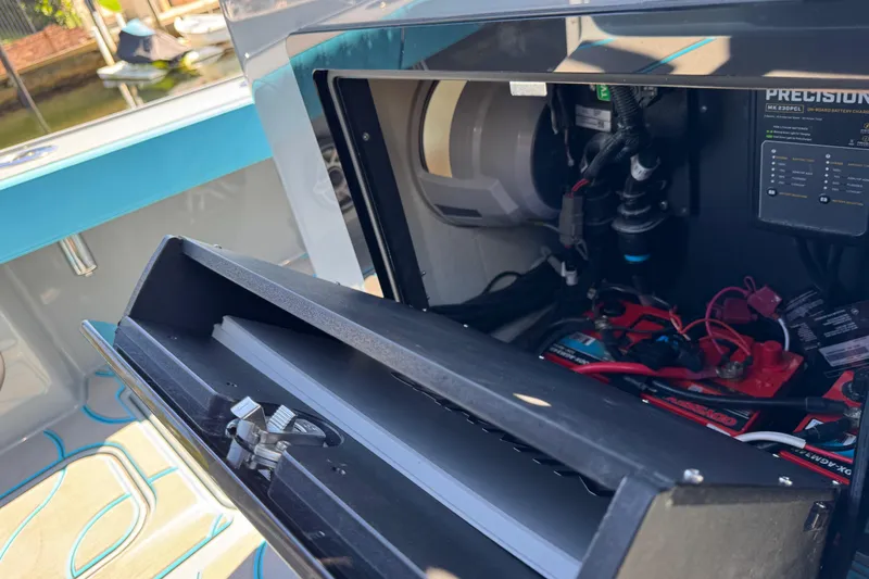Slide: The Image of 2026 Costa Custom Boats 264 HC battery compartment with wiring and charger. - 49