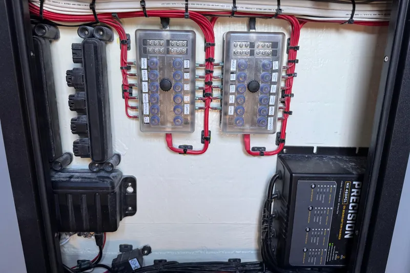 Slide: The Image of Electrical panel of 2026 Costa Custom Boats 264 HC with wiring and precision charger. - 55