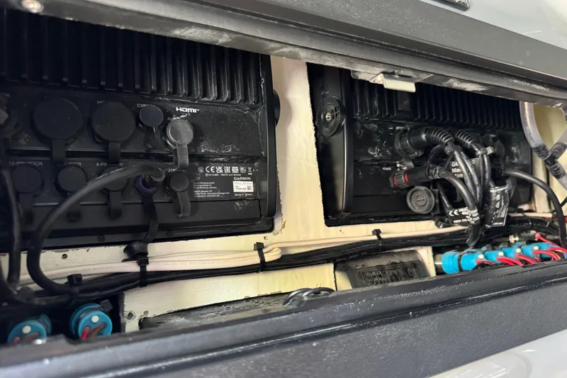 Slide: The Image of Electrical components inside a 2026 Costa Custom Boats 264 HC, featuring wiring and connectors. - 57