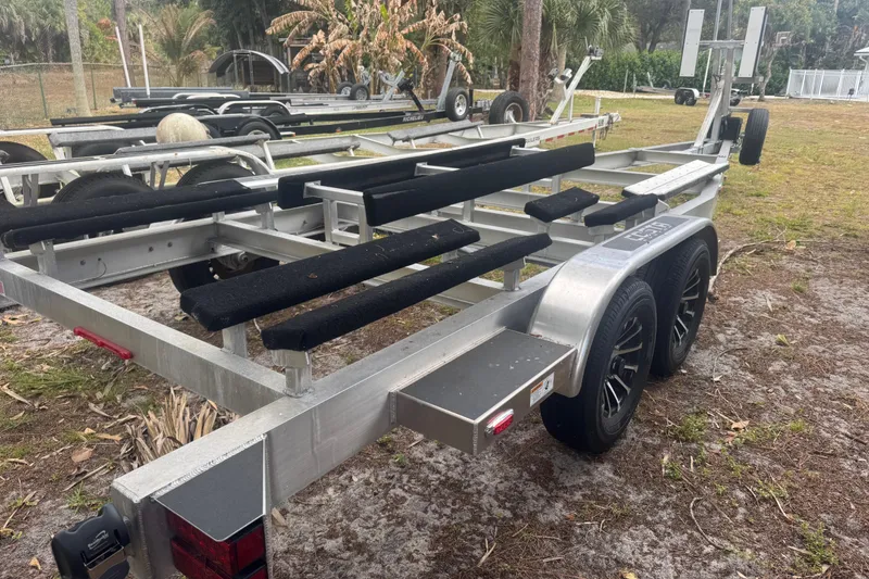 Slide: The Image of Trailer for 2026 Costa Custom Boats 264 HC, parked on grassy area. - 62