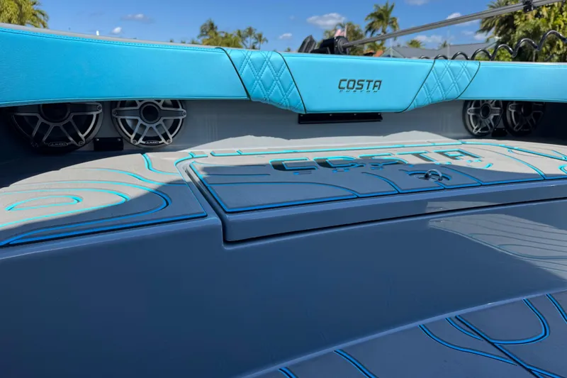 Slide: The Image of 2026 Costa Custom Boats 264 HC with blue accents and sleek design details. - 8