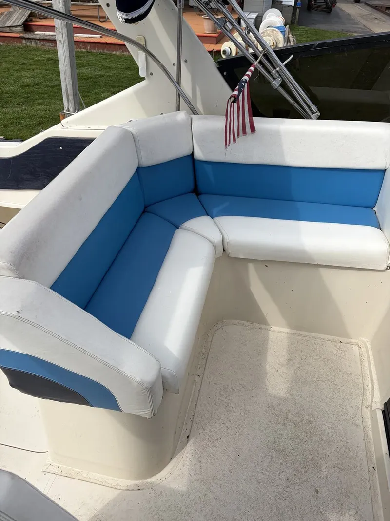 Slide: The Image of Seating area on a 1988 Silverton 34X boat, blue and white upholstery. - 4