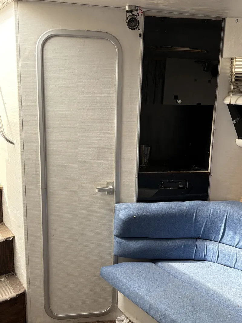 Slide: The Image of Interior of a 1988 Silverton 34X yacht with blue couch. - 7