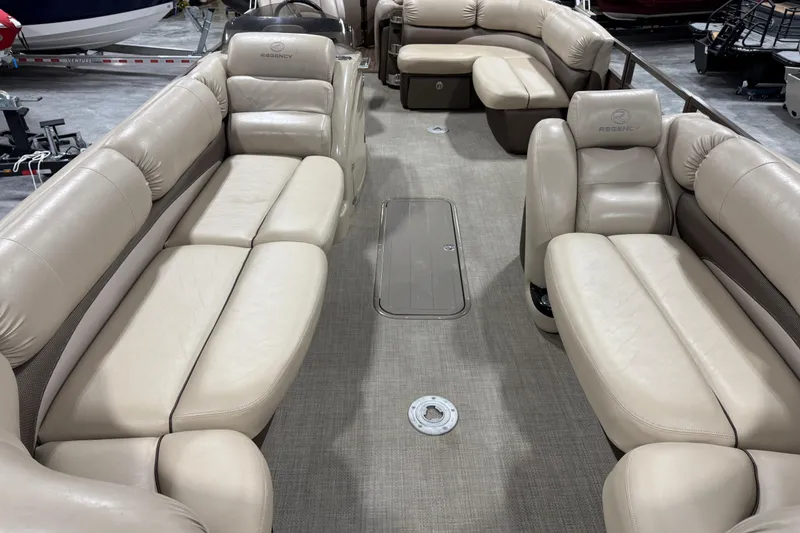 Slide: The Image of 2015 Sun Tracker Regency 254 XP3 pontoon boat interior with beige seating and carpeted floor. - 11