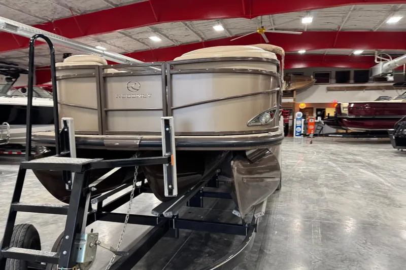 Slide: The Image of 2015 Sun Tracker Regency 254 XP3 pontoon boat displayed indoors on a trailer. - 5
