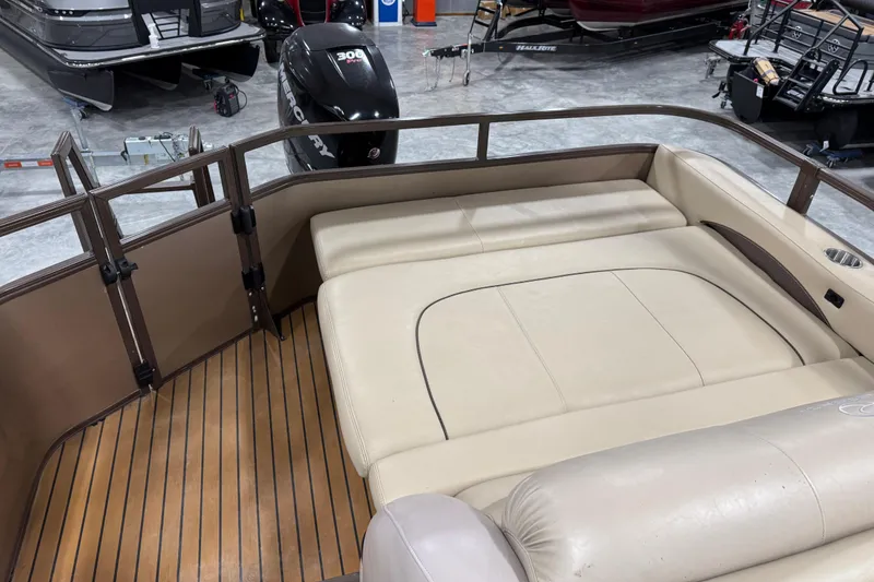 Slide: The Image of 2015 Sun Tracker Regency 254 XP3 boat interior with beige seating and wood flooring. - 8
