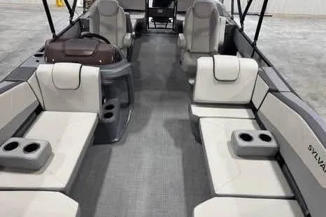 Slide: The Image of 2025 Sylvan A-22 boat interior with gray seating and cup holders. - 12