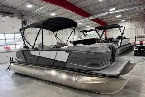 Slide: The Image of 2025 Sylvan A-22 pontoon boat in showroom, featuring sleek design and modern amenities. - 2